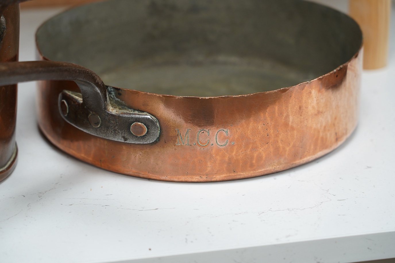 Three copper pans, one stamped RN Club, largest 63cm. Condition - fair